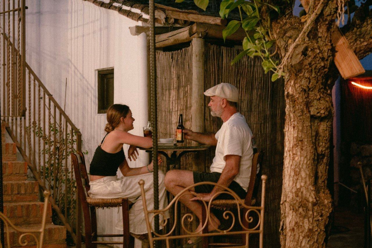A couple sharing evening drinks on the terrace
